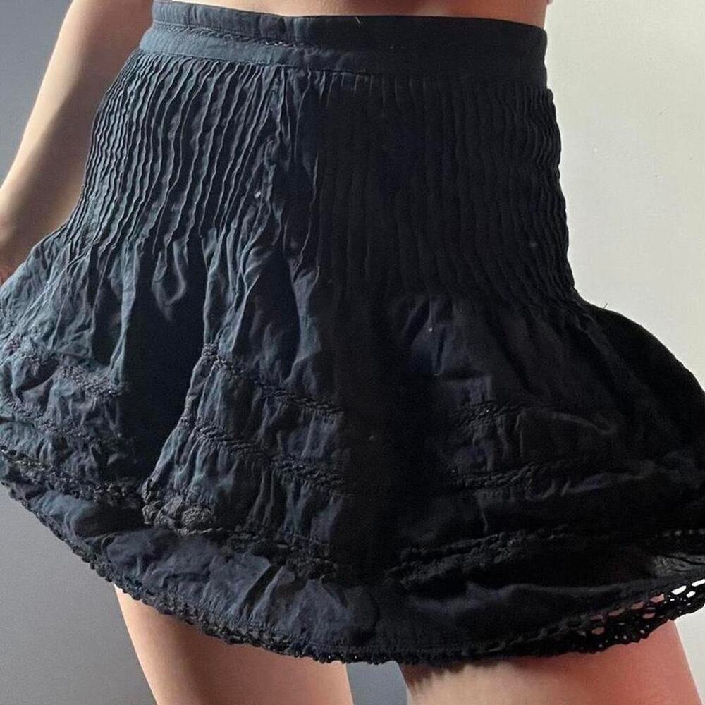 Free People black mini skirt with lace trim.